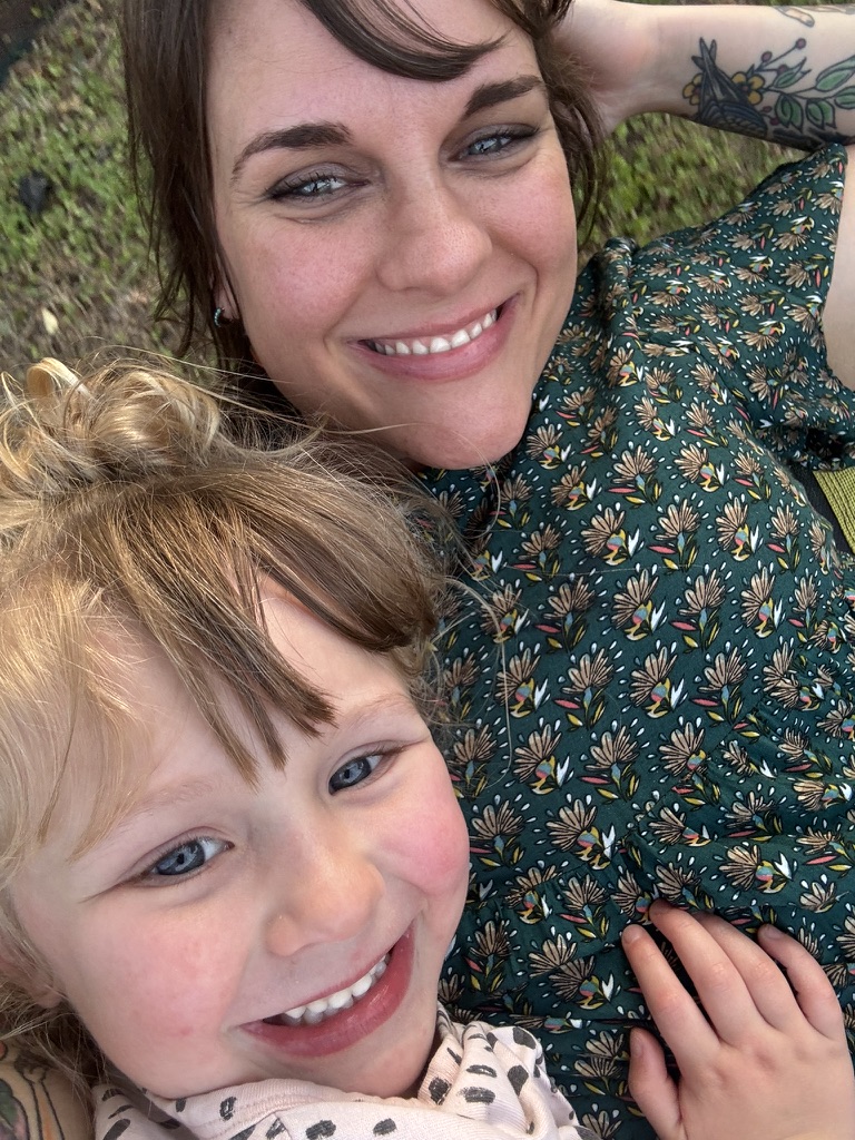 Faith and Willow smiling together outside